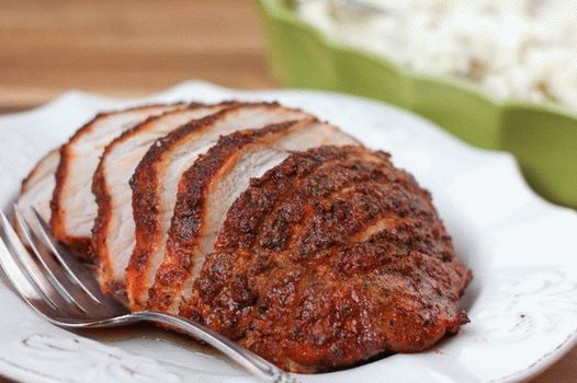Фотографија од варено свинско месо во бавен шпорет со билки